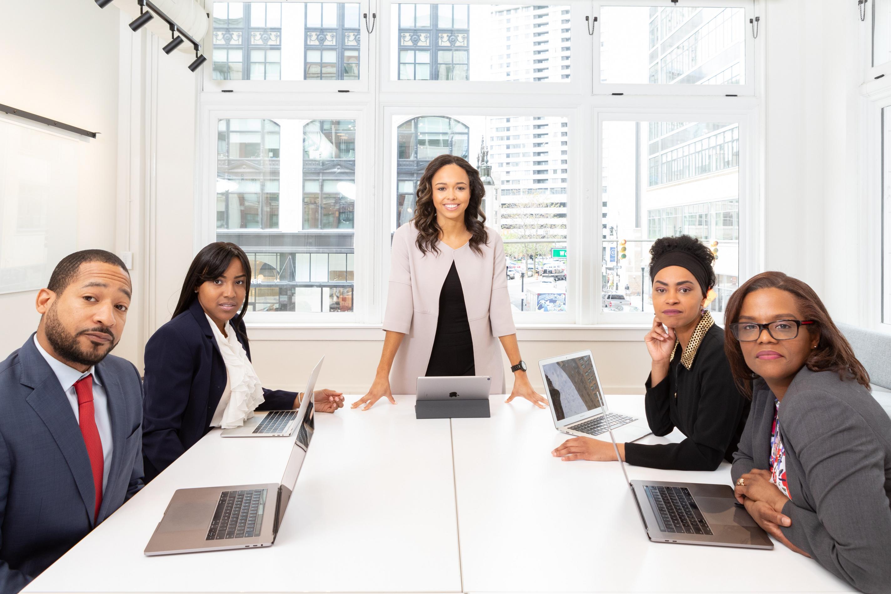 woman-standing-on-the-center-table-with-four-people-on-the-1367271.jpg
